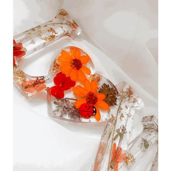 Pressed flower resin decor LOVE word art with real wildflowers and ladybug accents in clear resin letters