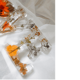 Pressed flower resin decor spelling LOVE with real wildflowers and a tiny ladybug inside clear resin letters