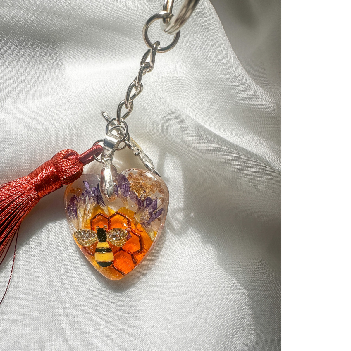 Honeybee Heart Bag Charm with rhinestone bee, pressed purple flowers, enamel bee charm, copper tassel, and clear resin heart keychain