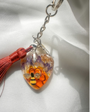 Honeybee Heart Bag Charm with rhinestone bee, pressed purple flowers, enamel bee charm, copper tassel, and clear resin heart keychain