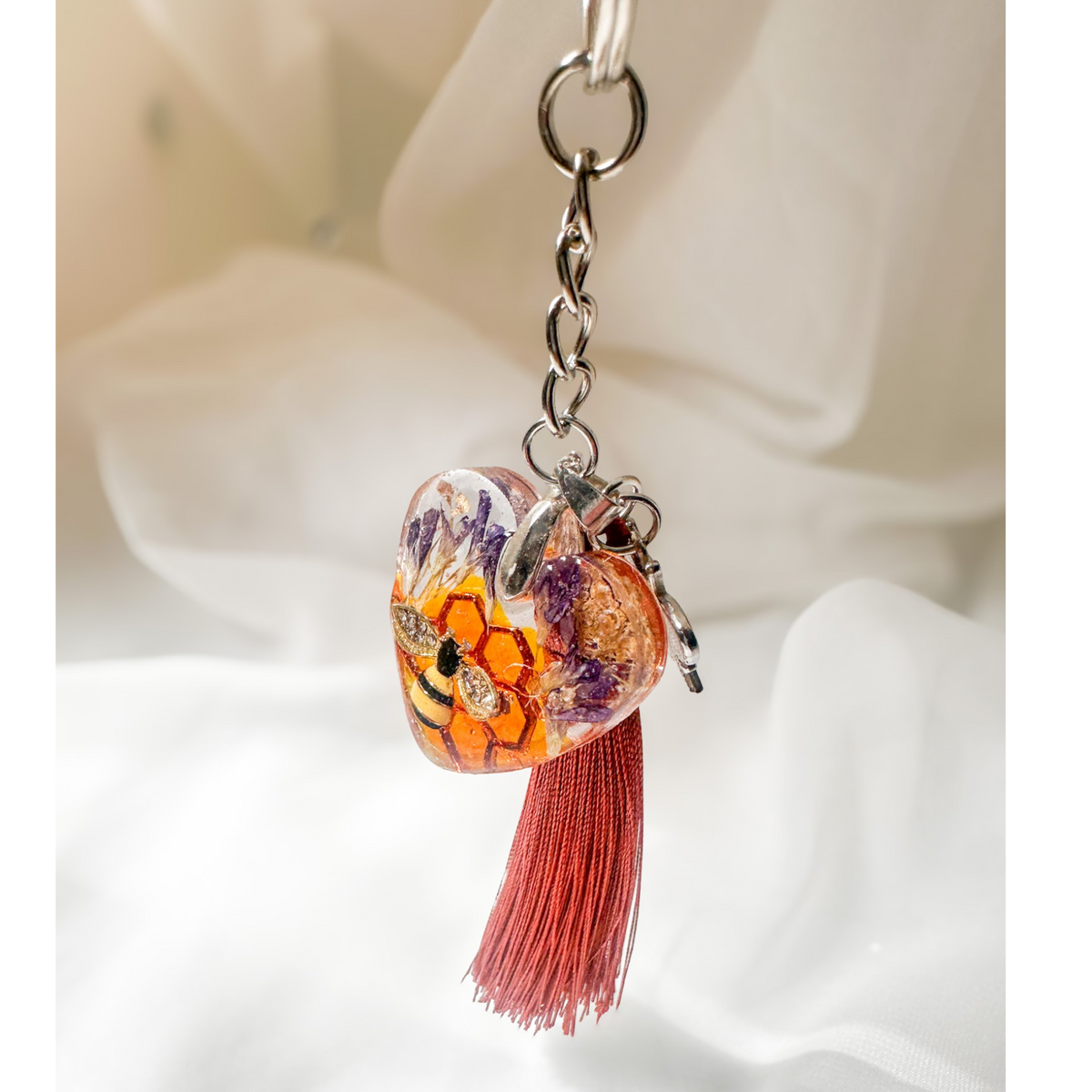 Honeybee heart bag charm with rhinestone bee, pressed purple flowers, enamel bee charm, and copper tassel in clear resin keychain