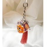 Honeybee heart bag charm with rhinestone bee, pressed purple flowers, enamel bee charm, and copper tassel in clear resin keychain