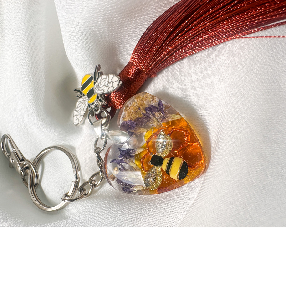 Honeybee Heart Bag Charm with rhinestone bee, pressed purple flowers, enamel bee charm, and copper tassel in heart-shaped resin keychain