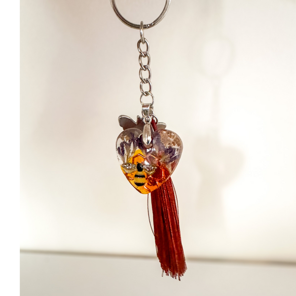 Honeybee Heart Bag Charm with rhinestone bee, pressed purple flowers, enamel bee charm, and copper tassel in clear resin heart keychain