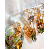 Boreal Mushroom LOVE word art with real hand-foraged mushrooms, ferns, moss, and gold leaf in clear resin letters