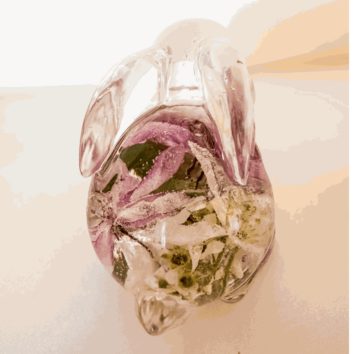 Pair of handmade apple blossom resin bunnies with preserved flowers inside