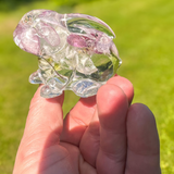 Two handmade apple blossom resin bunnies with real preserved flowers displayed as a matching pair