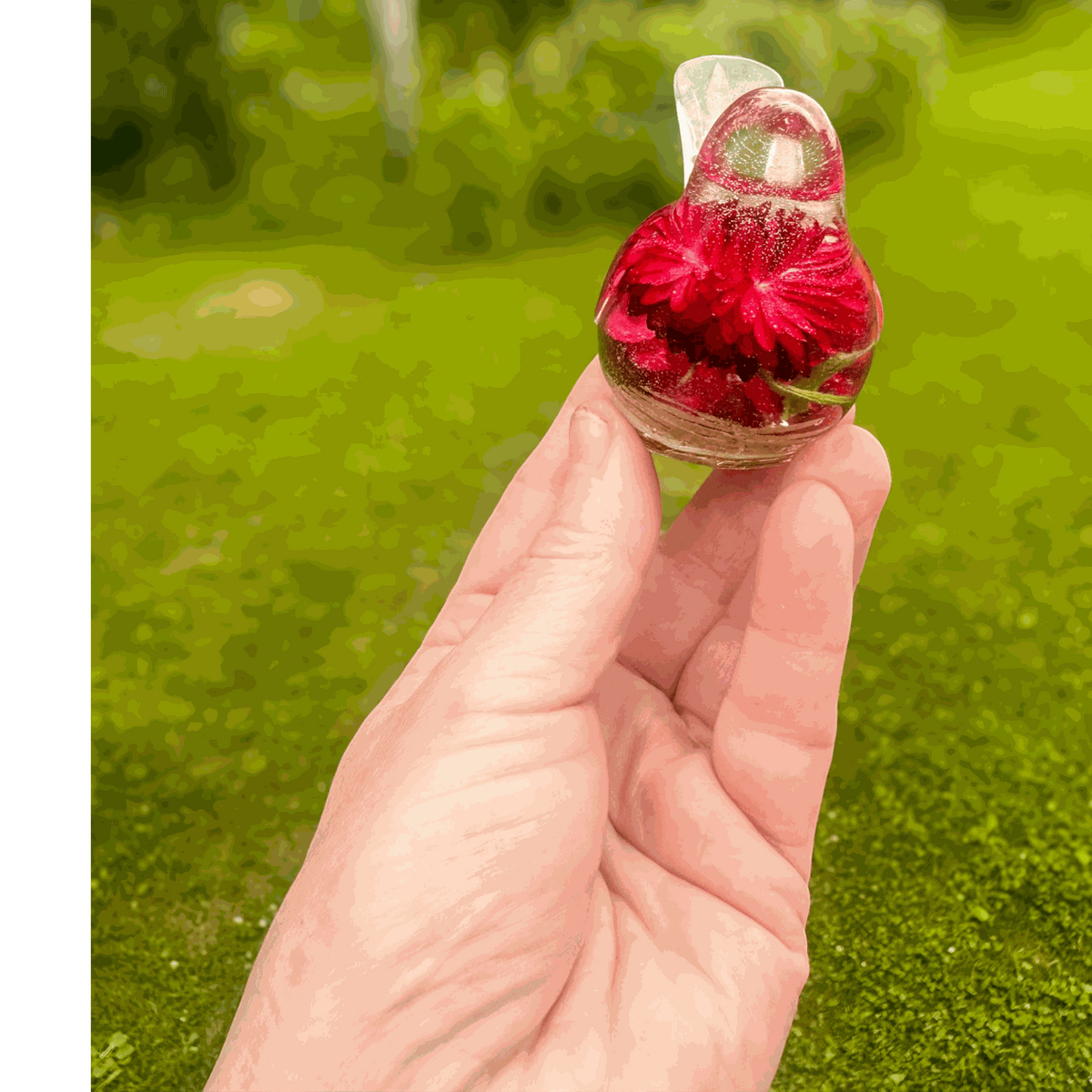 Handmade Crimson Meadow Songbird resin decor with real deep pink strawflowers and green fern inside clear resin