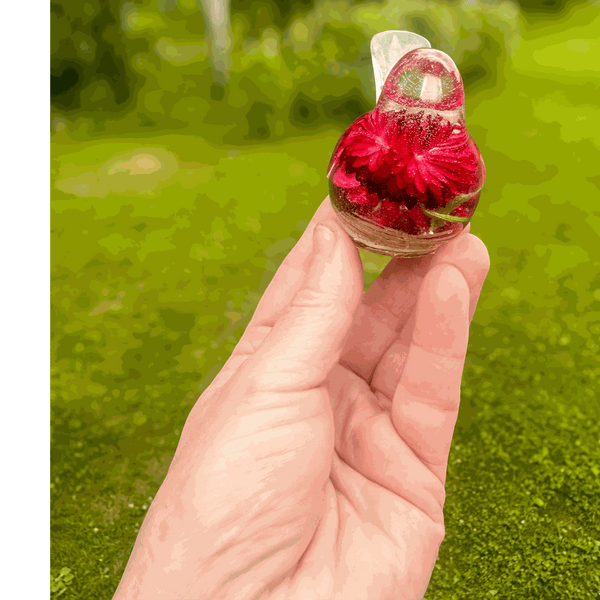 Handmade Crimson Meadow Songbird resin decor with real deep pink strawflowers and green fern inside clear resin