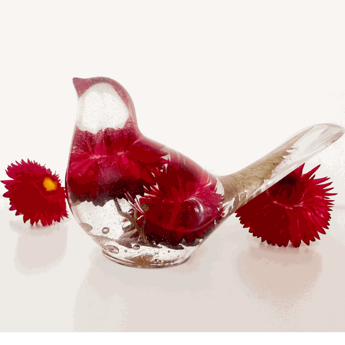 Crimson Meadow Songbird resin decor with preserved pink strawflowers and green fern handcrafted in clear resin