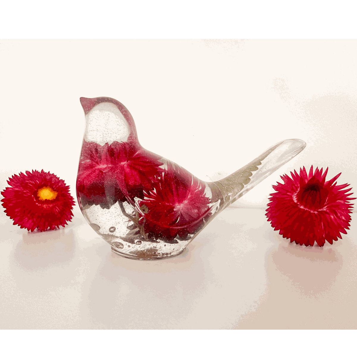 Handmade Crimson Meadow Songbird resin decor with preserved deep pink strawflowers and green fern
