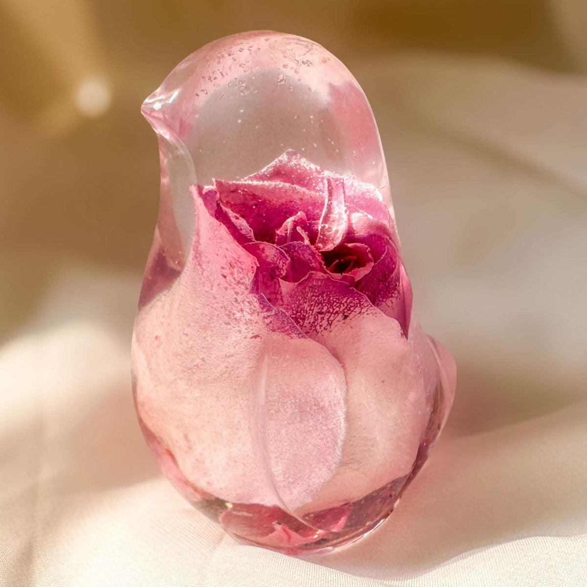 Pink rose resin bird decor featuring a preserved soft pink rose inside clear resin handcrafted songbird sculpture