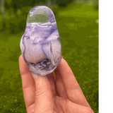 Purple rose preserved inside clear resin songbird decor with lavender tones