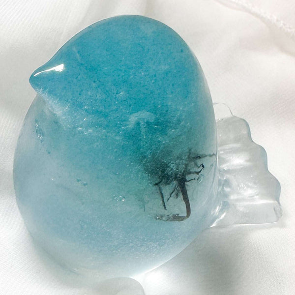 Glow in the dark resin bird decor with preserved dandelion puff inside glowing blue resin sculpture