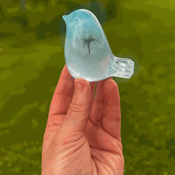 Handmade glow in the dark resin bird decor with real dandelion puff inside glowing blue resin