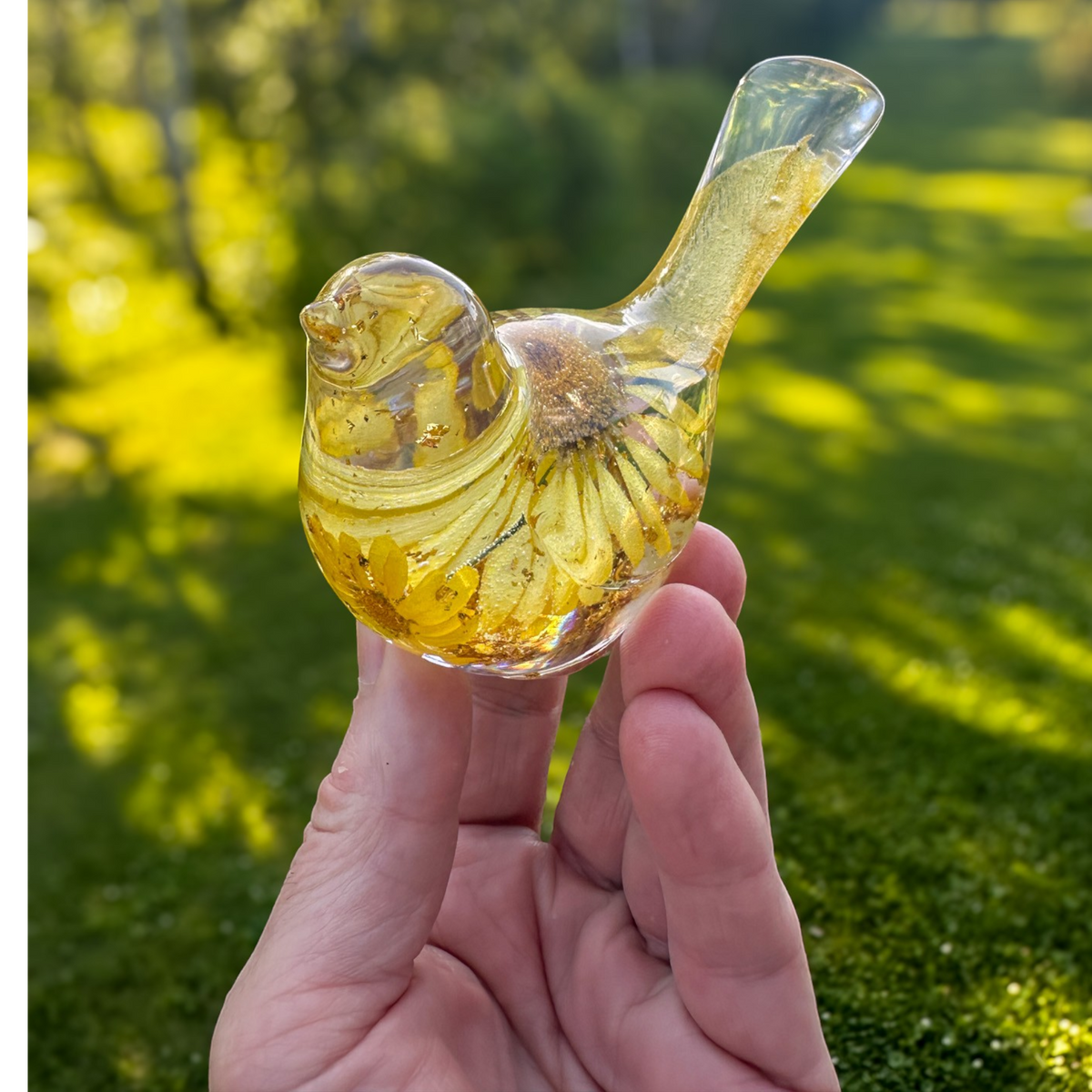 Handcrafted yellow floral resin bird with real daisy and gold leaf accents