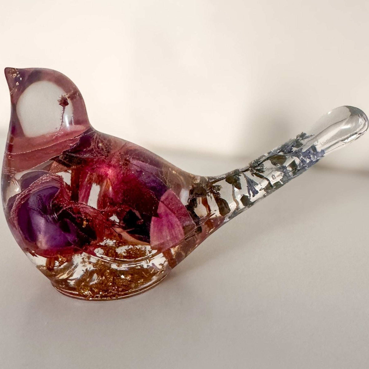 Handmade clear resin bird with real fuchsia flowers and gold leaf accents