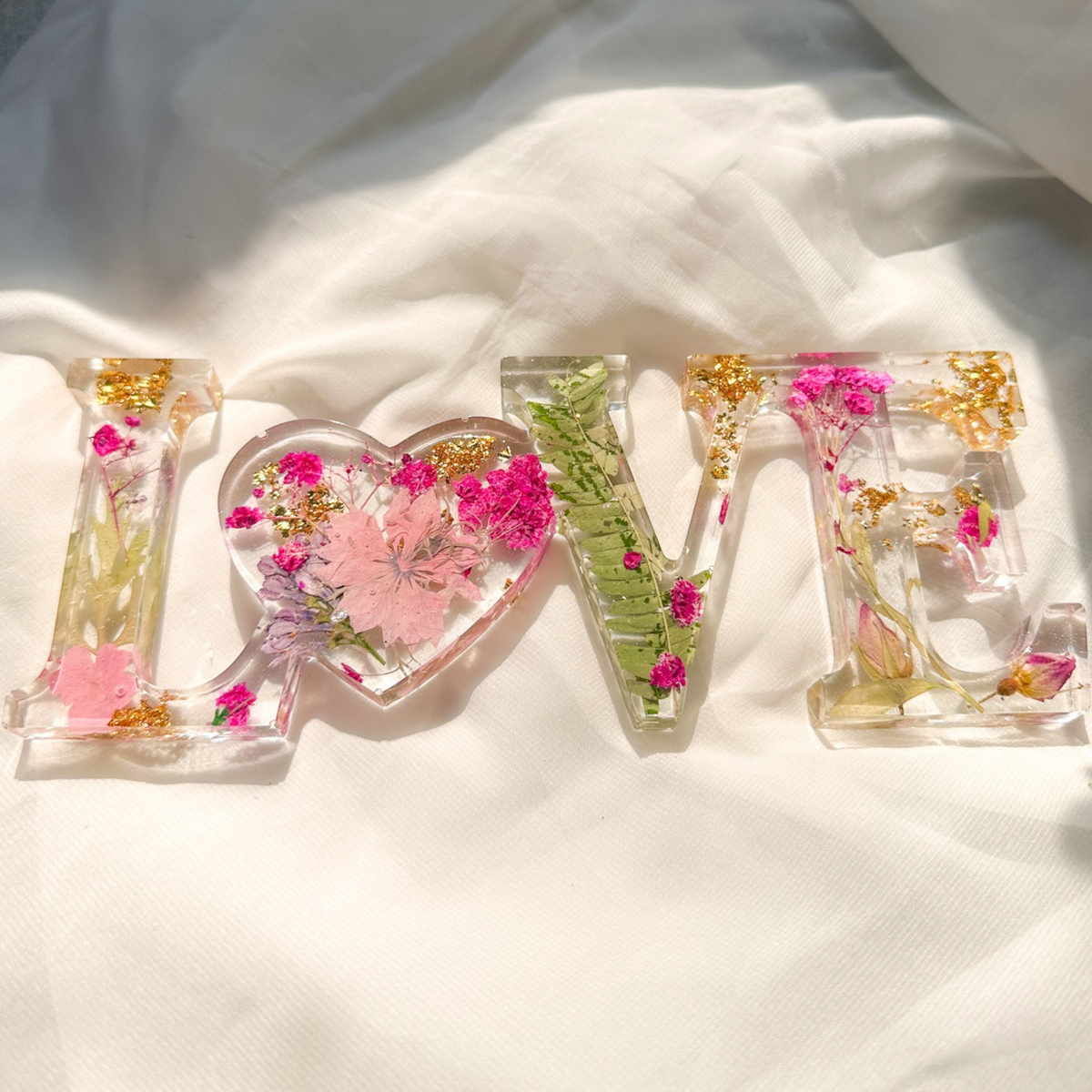 Fuchsia Garden LOVE resin word art with real pressed pink and fuchsia flowers, fern fronds, and gold leaf flakes