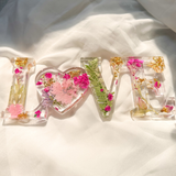 Fuchsia Garden LOVE resin word art with real pressed pink and fuchsia flowers, fern fronds, and gold leaf flakes