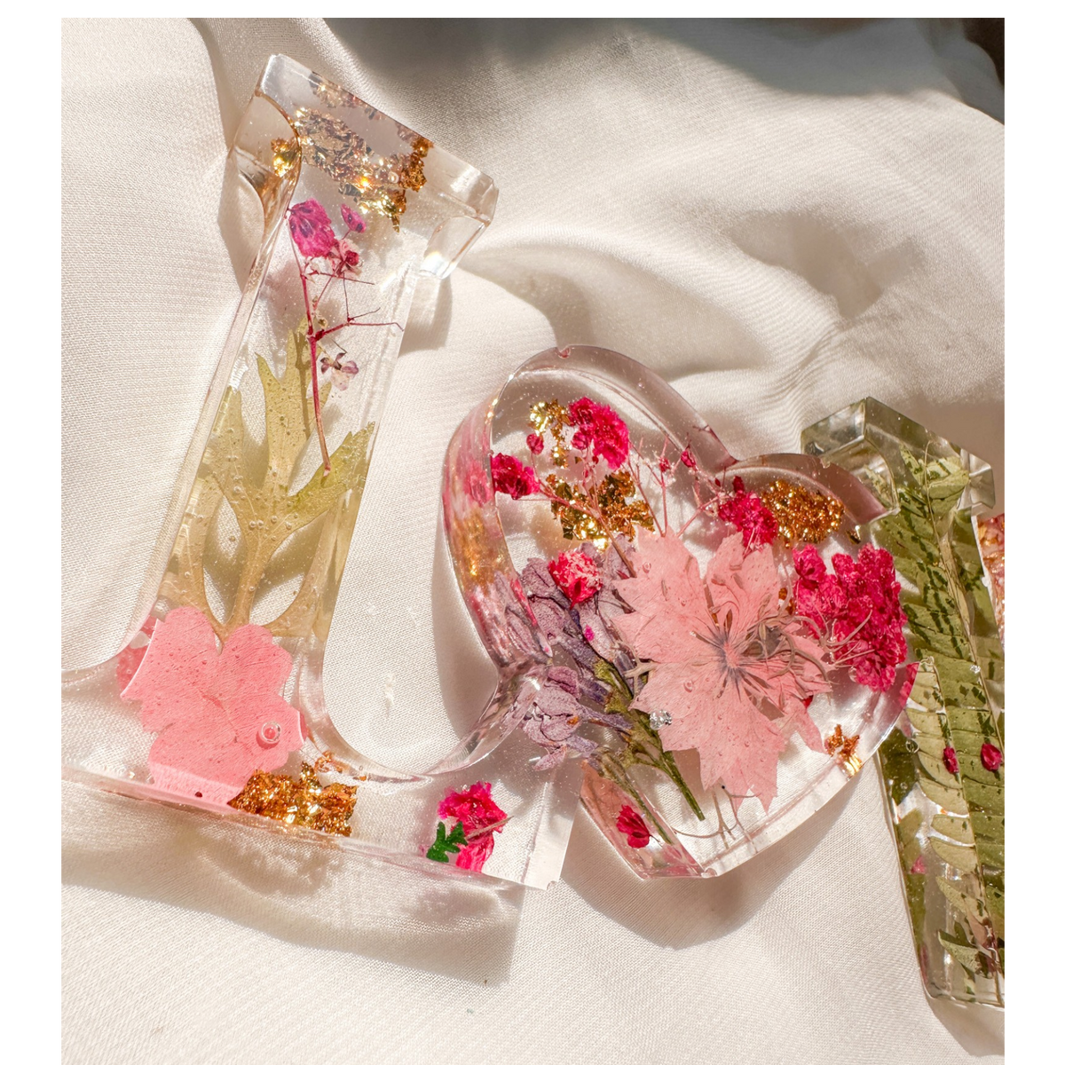 Fuchsia Garden LOVE resin word art with pressed pink and fuchsia flowers, fern fronds, and gold leaf flakes