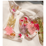 Fuchsia Garden LOVE resin word art with pressed pink and fuchsia flowers, fern fronds, and gold leaf flakes