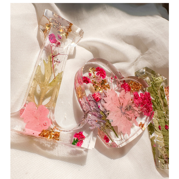 Fuchsia Garden LOVE resin word art with pressed pink and fuchsia flowers, fern fronds, and gold leaf flakes
