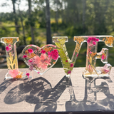 Fuchsia Garden LOVE resin word art with pink and fuchsia flowers, fern fronds, and gold leaf flakes