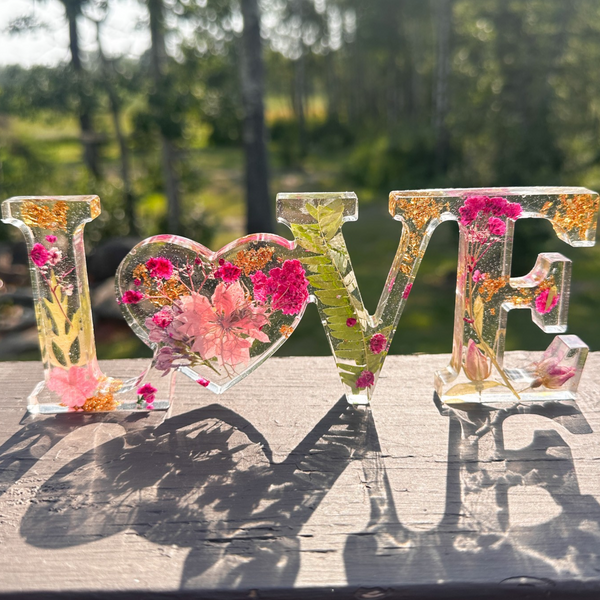 Fuchsia Garden LOVE resin word art with pink and fuchsia flowers, fern fronds, and gold leaf flakes