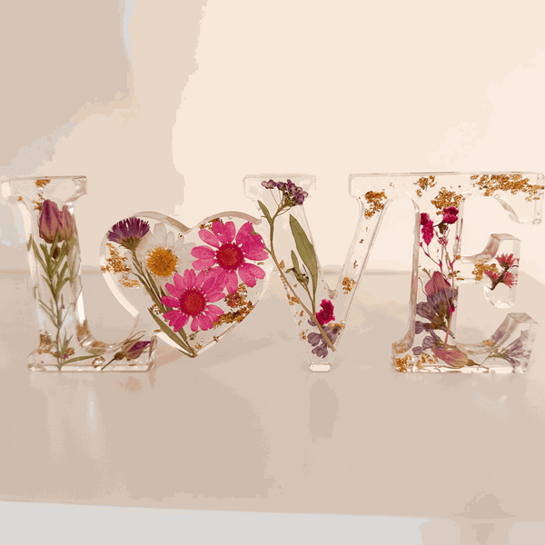 Wildflower resin word art LOVE with pink daisies, purple wildflowers, rose buds, and gold leaf flakes