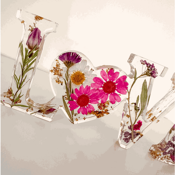 Wildflower resin word art with pink daisies, white daisy, purple wildflowers, rose buds, and gold leaf flakes in LOVE letters