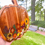 Handcrafted wooden pumpkin tray with real pressed sunflower, dried botanicals, bee charm, and gold glitter, perfect for fall decor