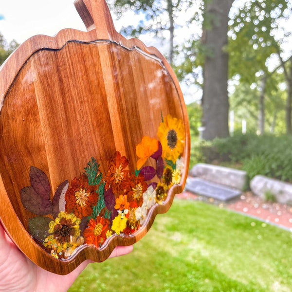 Handcrafted wooden pumpkin tray with real pressed sunflower, dried botanicals, bee charm, and gold glitter, perfect for fall decor