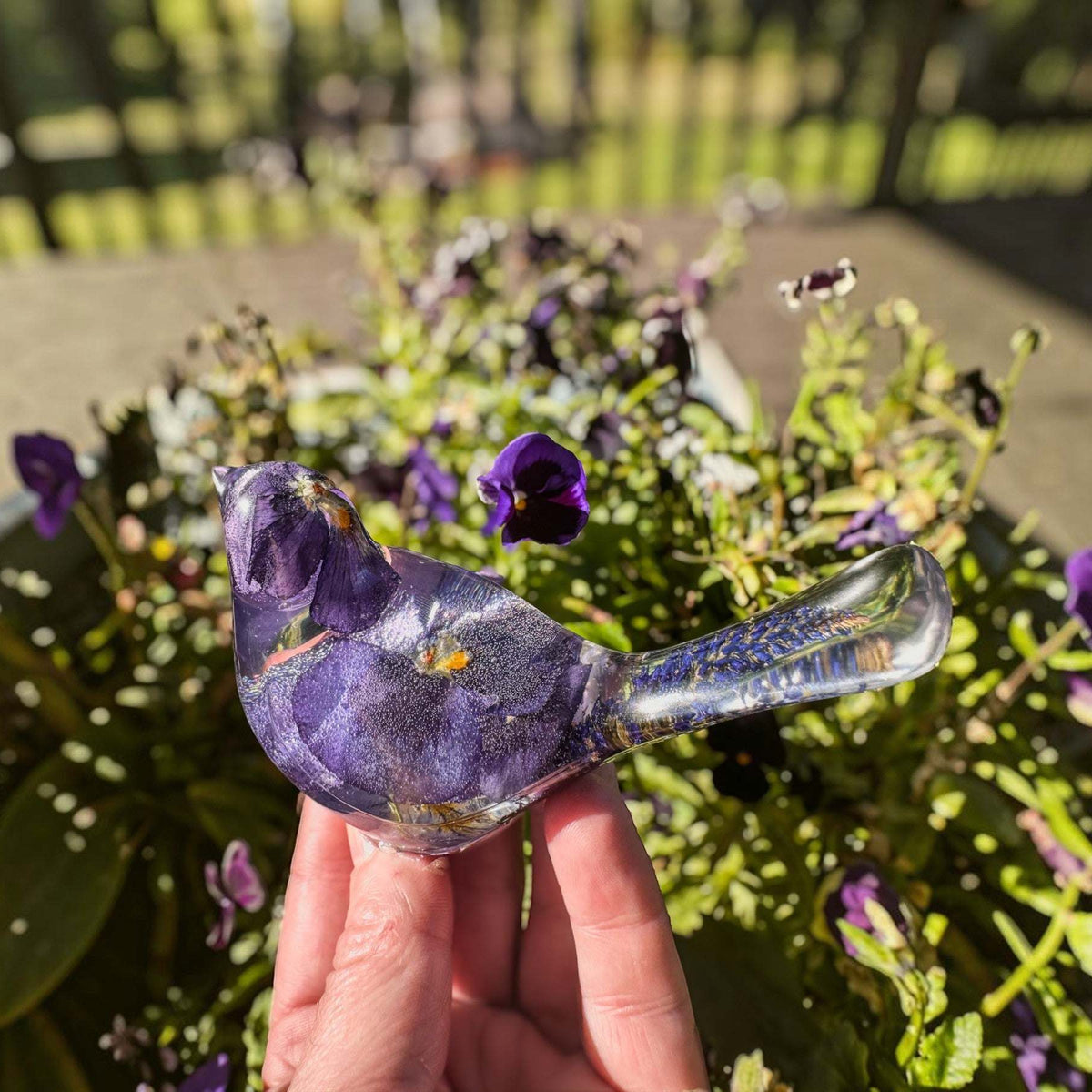 Purple Pansy resin bird decor with real pressed purple flowers and clear resin tail featuring purple sage embellishments.