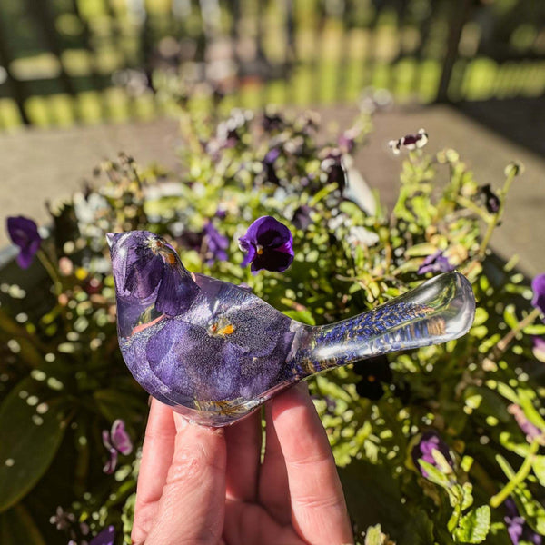 Purple Pansy resin bird decor with real pressed purple flowers and clear resin tail featuring purple sage embellishments.