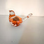 Resin bird decor with orange sunflower encased inside, clear tail featuring small flower accents, and copper leaf base shimmer.