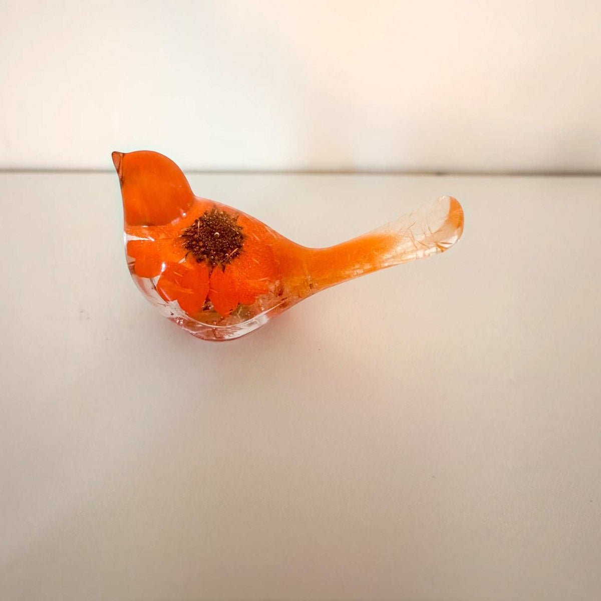 Orange sunflower resin bird decor with a bright orange flower body and clear tail featuring delicate floral accents