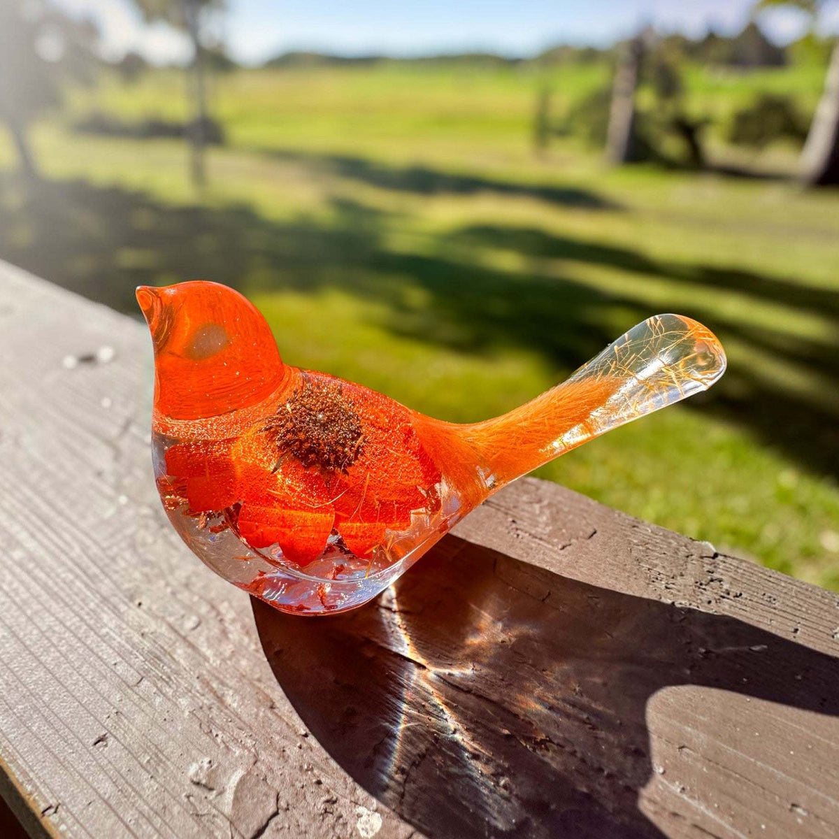Orange sunflower resin bird decor with bright orange petals, clear resin tail, and embedded flower details in vibrant hues
