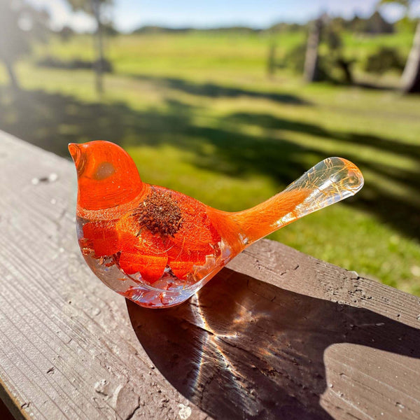 Orange sunflower resin bird decor with bright orange petals, clear resin tail, and embedded flower details in vibrant hues
