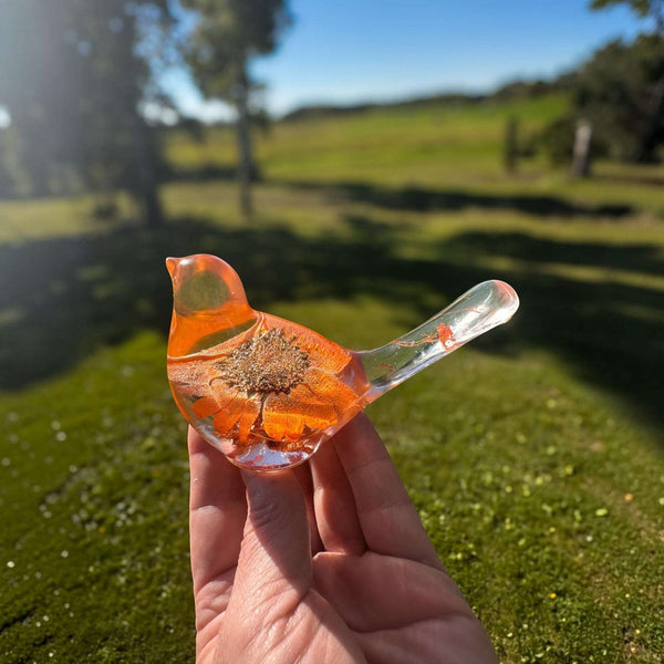 Orange sunflower resin bird decor with a bright orange flower encased in clear resin and copper leaf detailing at the base.
