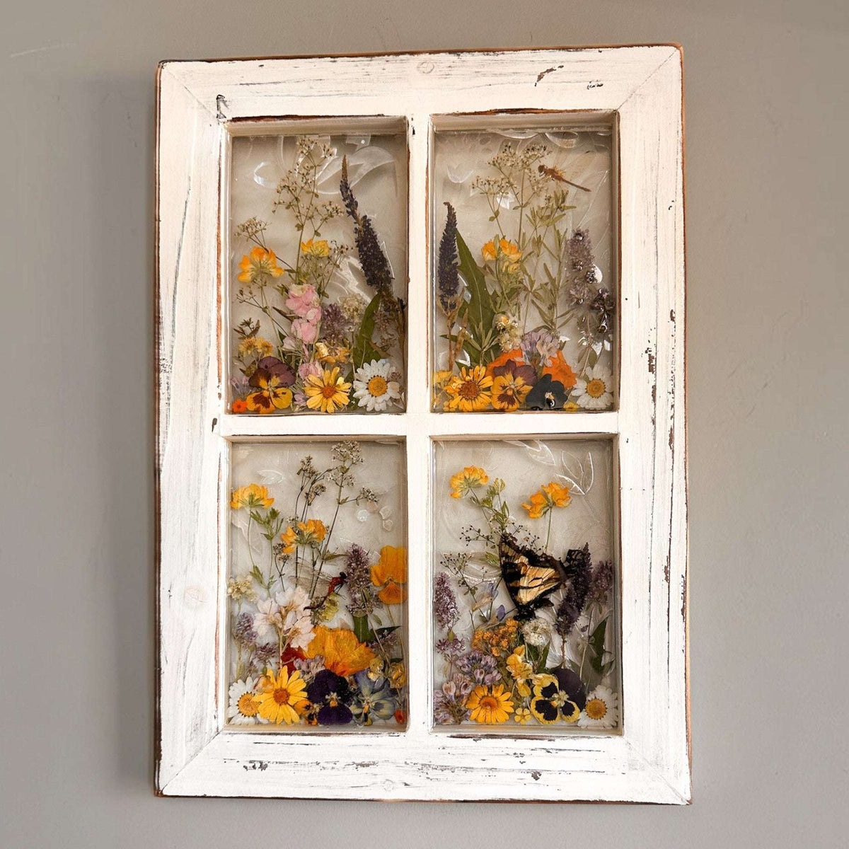 Pressed Flower Window Frame with soft white distressed wood and four clear resin panes filled with real dried wildflowers and insects including a swallowtail butterfly and two dragonflies