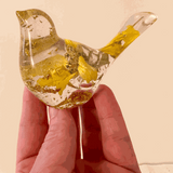 Clear resin bird decor with embedded real dried Sunflower petals and gold leaf accents creating a warm, sunlit effect.