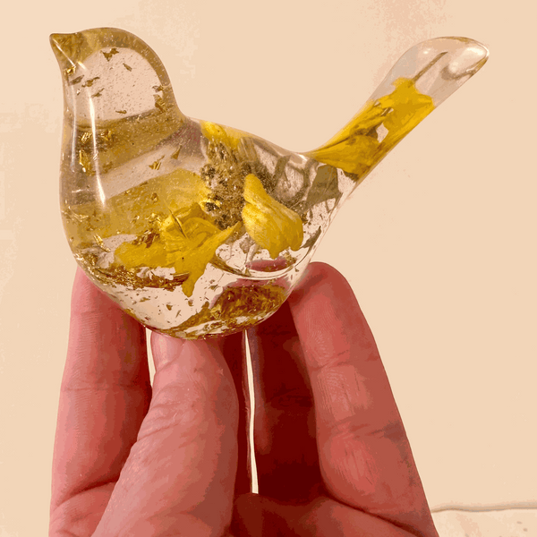 Clear resin bird decor with embedded real dried Sunflower petals and gold leaf accents creating a warm, sunlit effect.