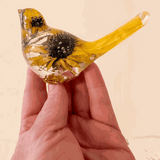 Sunflower resin bird decor with clear hand-poured resin, real dried sunflower blooms, and yellow-tinted tail accents.
