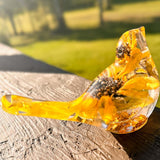 Sunflower resin bird decor with clear body, embedded real dried mini sunflower petals, and gold leaf accents inside.