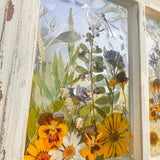 Pressed Flower Window Frame with soft white distressed wood, clear resin panes holding real dried yellow, white, and purple wildflowers and greenery