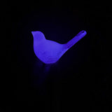 Glow in the Dark Resin Bird, violet translucent resin with a softly glowing finish and raised tail silhouette