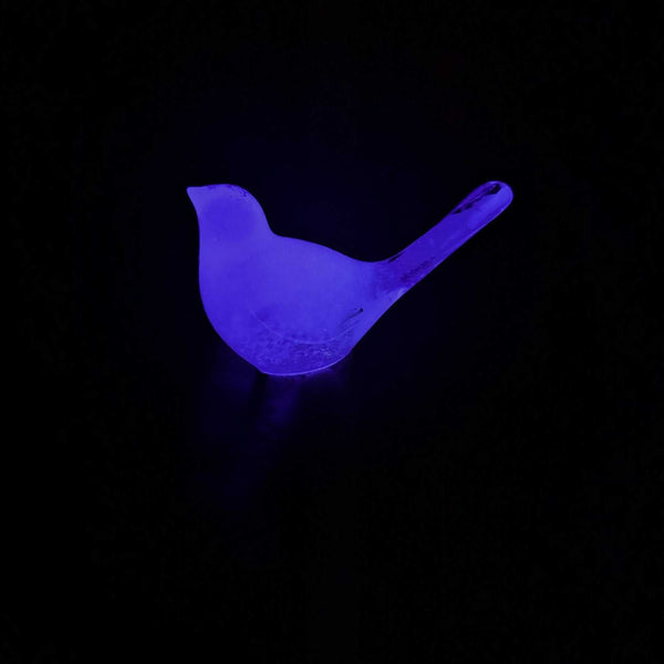 Glow in the Dark Resin Bird, violet translucent resin with a softly glowing finish and raised tail silhouette