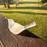 Glow in the Dark Resin Bird, translucent milky white with violet glitter and a rounded beak-shaped tail.