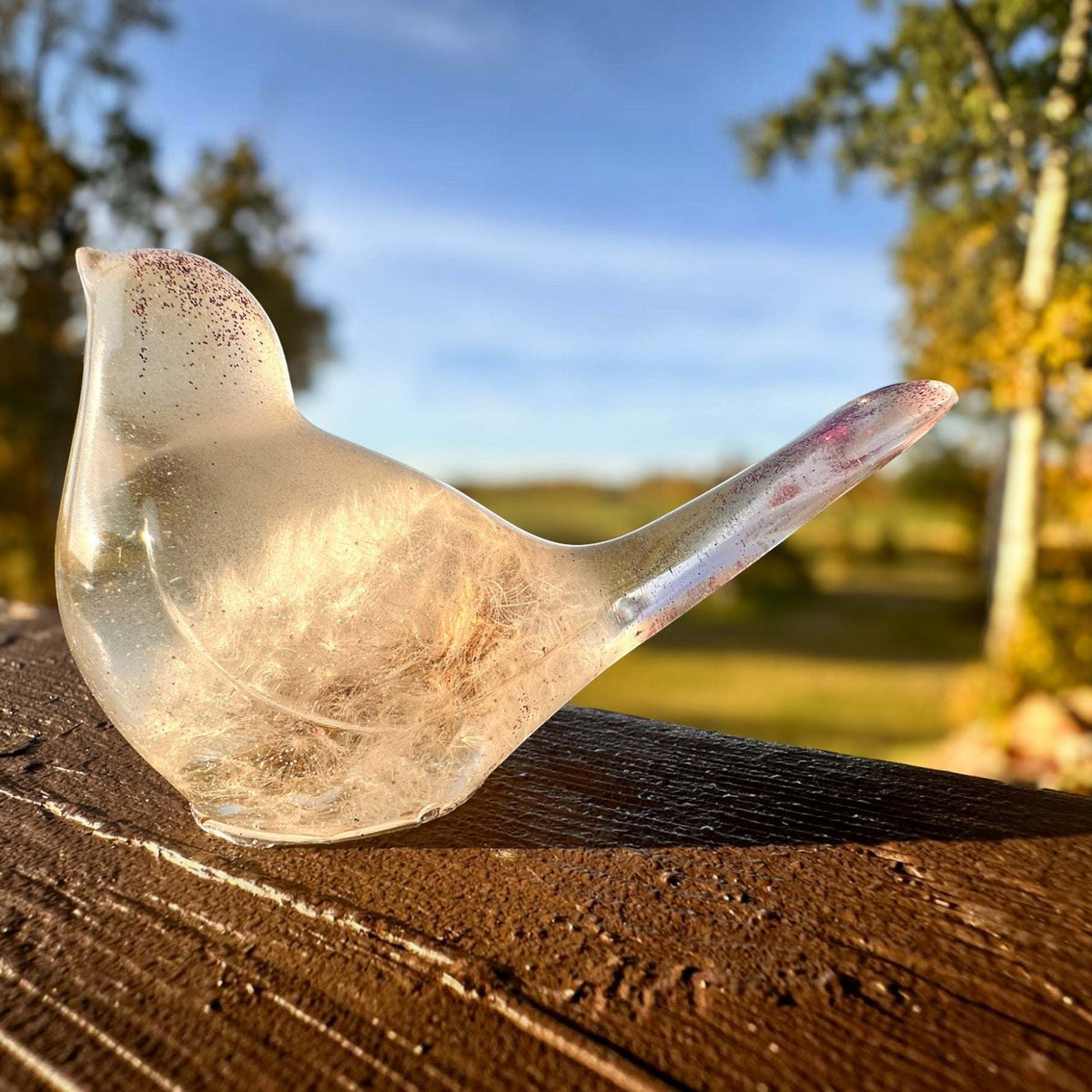 Glow in the Dark Resin Bird, translucent milky resin with violet glitter and a real dandelion puff inside