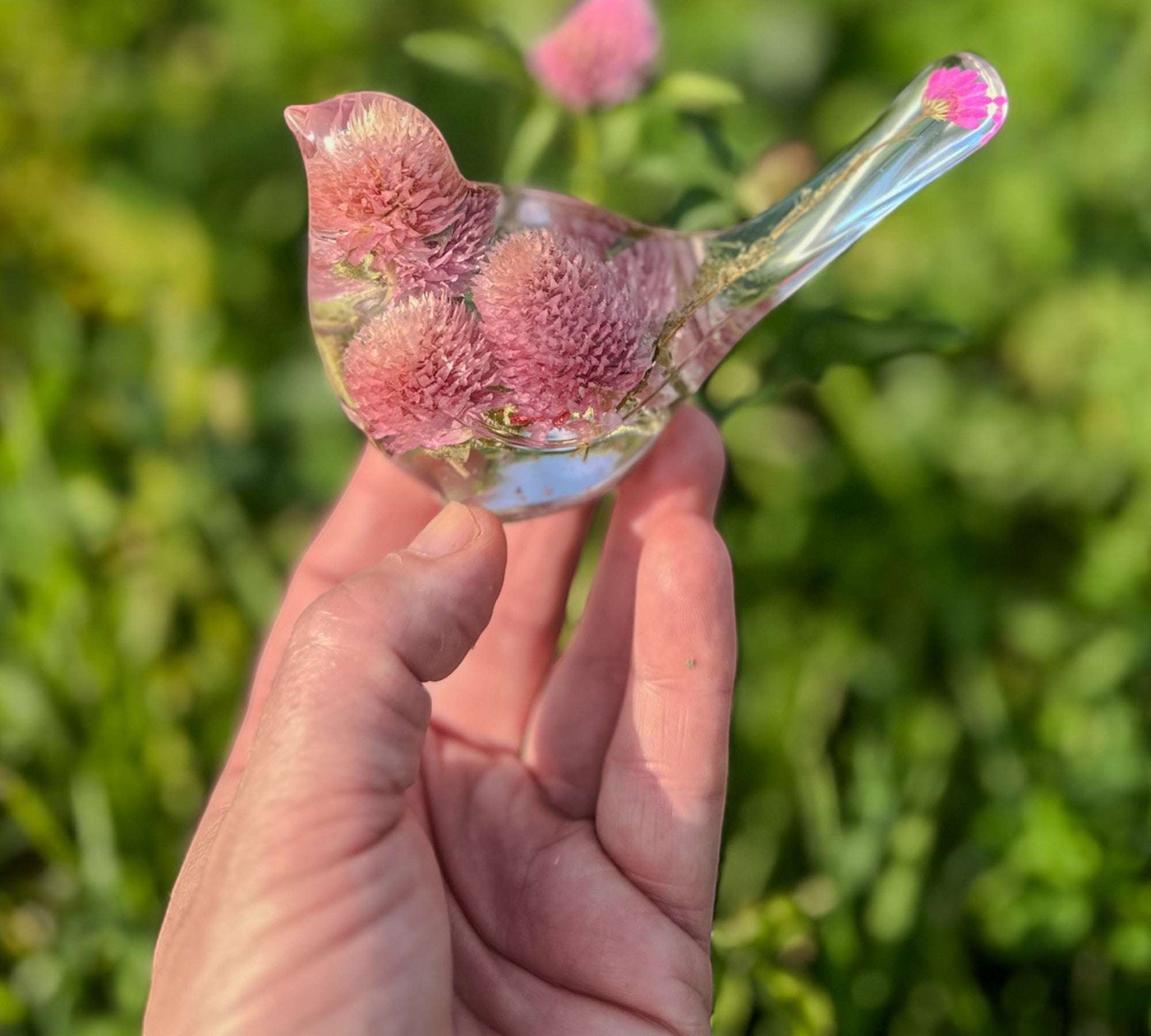 Dried flower resin bird with pink and lilac clover blossoms, clear resin body and delicate floral tail detail